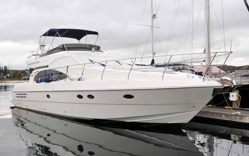 Slide: The Image of 1996 Azimut 54 | Calmati Luxury 1996 Azimut Cinquantaquattro yacht docked at marina under cloudy sky. - 6308843