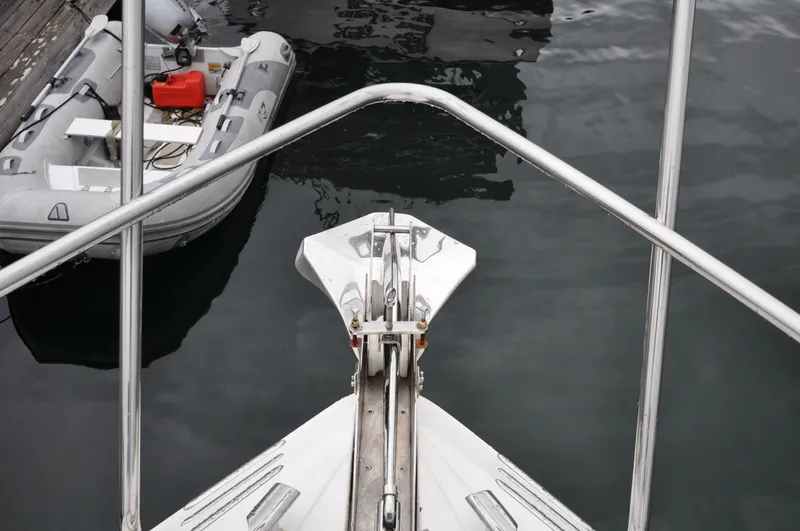 Slide: The Image of 1996 Azimut 54 | Calmati Bow of 1996 Azimut Cinquantaquattro yacht with dinghy in marina. - 6308596