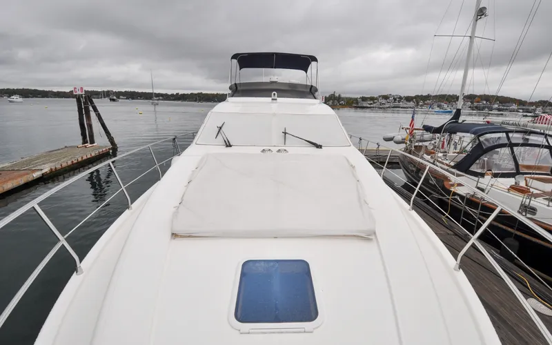 Slide: The Image of 1996 Azimut 54 | Calmati 1996 Azimut Cinquantaquattro yacht docked at marina on a cloudy day. - 6308878