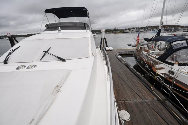 Slide: The Image of 1996 Azimut 54 | Calmati 1996 Azimut Cinquantaquattro yacht docked beside wooden pier, showcasing sleek design. - 6308600