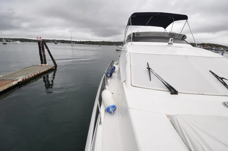 Slide: The Image of 1996 Azimut 54 | Calmati Deck view of a 1996 Azimut Cinquantaquattro yacht with fenders and wipers. - 6308601