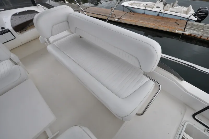 Slide: The Image of 1996 Azimut 54 | Calmati White seating area on a 1996 Azimut Cinquantaquattro yacht, docked by the water. - 6308782