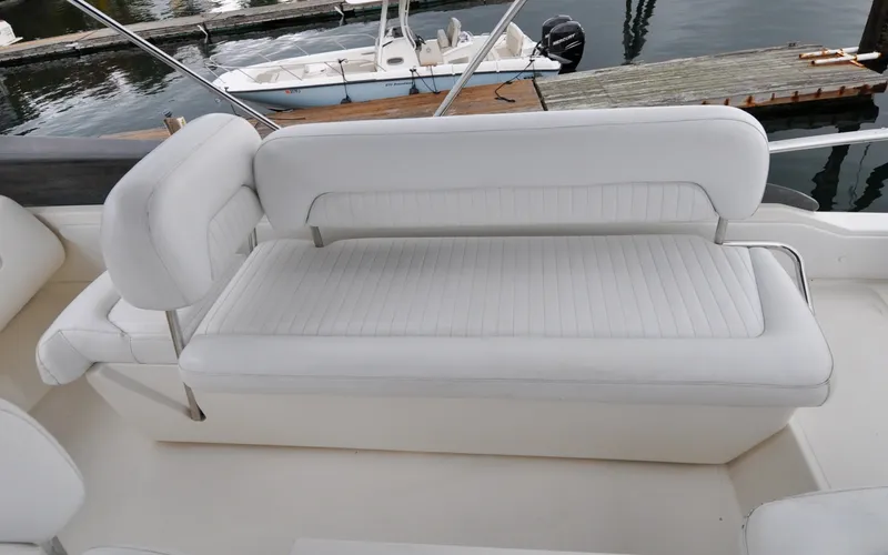 Slide: The Image of 1996 Azimut 54 | Calmati White leather seating on 1996 Azimut Cinquantaquattro yacht, docked by the water. - 6308887