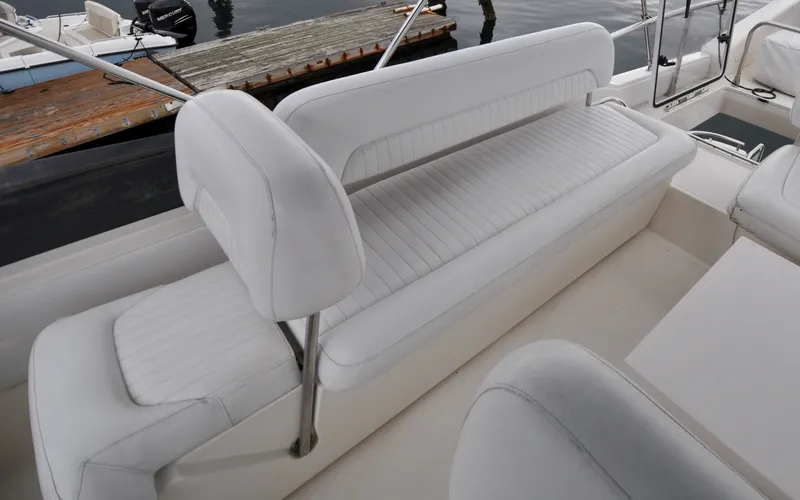 Slide: The Image of 1996 Azimut 54 | Calmati White leather seating on a 1996 Azimut Cinquantaquattro yacht, docked by the water. - 6308888