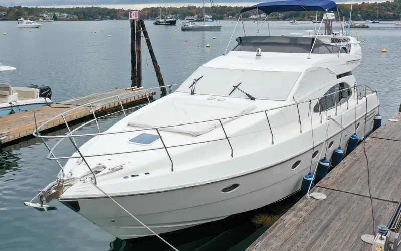 Slide: The Image of 1996 Azimut 54 | Calmati 1996 Azimut Cinquantaquattro yacht docked at marina on a cloudy day. - 6309019