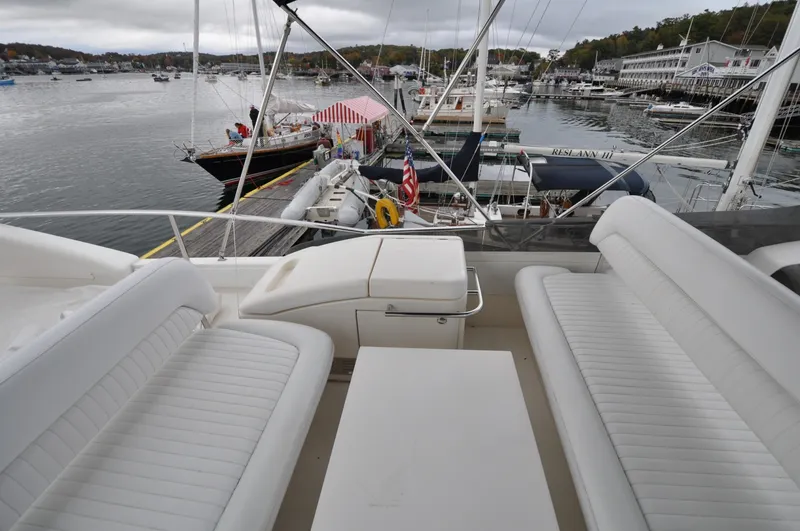 Slide: The Image of 1996 Azimut 54 | Calmati 1996 Azimut Cinquantaquattro yacht with white seating, docked in a scenic marina. - 6308900