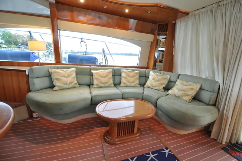 Slide: The Image of 1996 Azimut 54 | Calmati Luxurious interior of 1996 Azimut Cinquantaquattro yacht with elegant curved sofa and wooden table. - 6308609