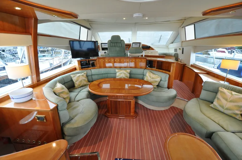 Slide: The Image of 1996 Azimut 54 | Calmati Luxurious interior of a 1996 Azimut Cinquantaquattro yacht with elegant seating and wooden accents. - 6308612