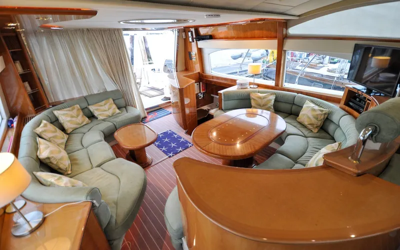 Slide: The Image of 1996 Azimut 54 | Calmati Luxurious interior of 1996 Azimut Cinquantaquattro yacht with plush seating and elegant wood finishes. - 6308988