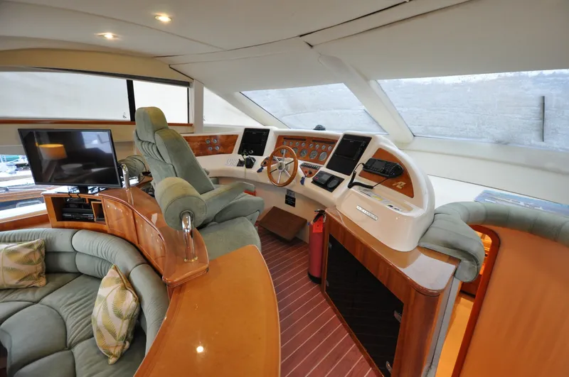 Slide: The Image of 1996 Azimut 54 | Calmati Luxurious interior of a 1996 Azimut Cinquantaquattro yacht with plush seating and modern helm. - 6308638