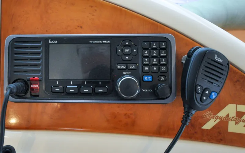 Slide: The Image of 1996 Azimut 54 | Calmati VHF marine radio on 1996 Azimut Cinquantaquattro yacht dashboard, featuring Icom IC-M605 model. - 6308920