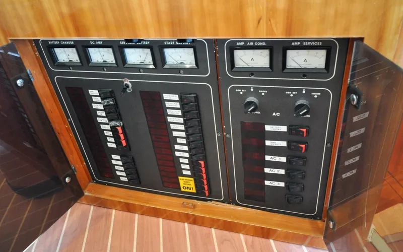 Slide: The Image of 1996 Azimut 54 | Calmati Electrical control panel on a 1996 Azimut Cinquantaquattro yacht, featuring gauges and switches. - 6308934