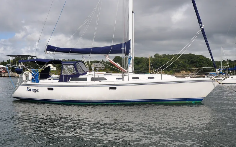 Slide: The Image of 1993 Catalina 42 | Kanga 1993 Catalina 42 sailboat named Kanga on calm water under cloudy sky. - 6318816