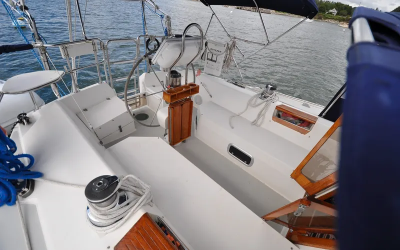 Slide: The Image of 1993 Catalina 42 | Kanga Cockpit of a 1993 Catalina 42 sailboat with wooden accents and nautical equipment. - 6318895
