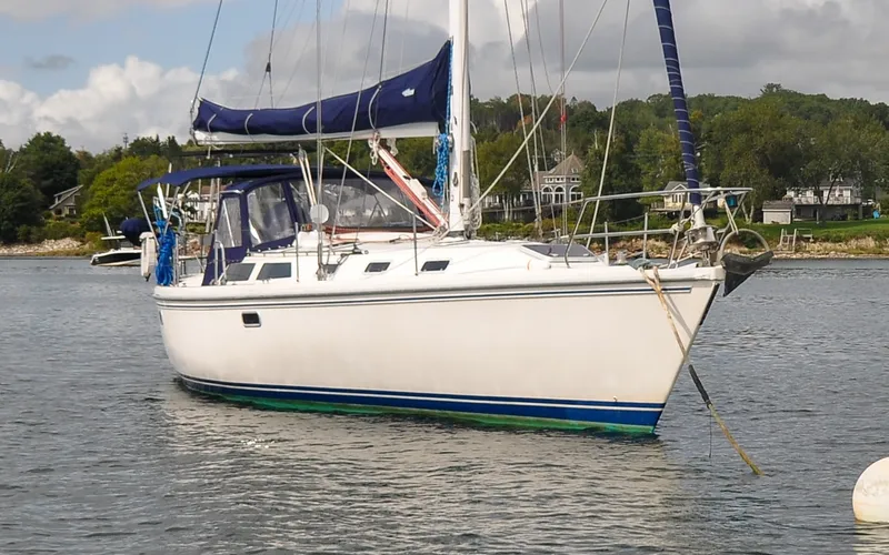 Slide: The Image of 1993 Catalina 42 | Kanga Sailboat Catalina 42, 1993 model, anchored in a scenic coastal area. - 6318825