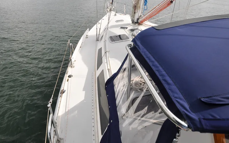 Slide: The Image of 1993 Catalina 42 | Kanga 1993 Catalina 42 sailboat deck with blue canopy on calm water. - 6318859