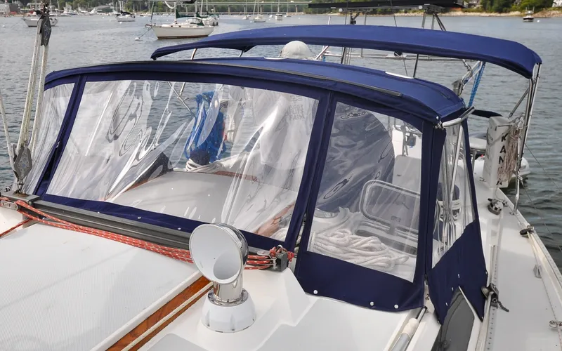 Slide: The Image of 1993 Catalina 42 | Kanga 1993 Catalina 42 sailboat with blue canvas cover and clear windows on a calm waterway. - 6318867