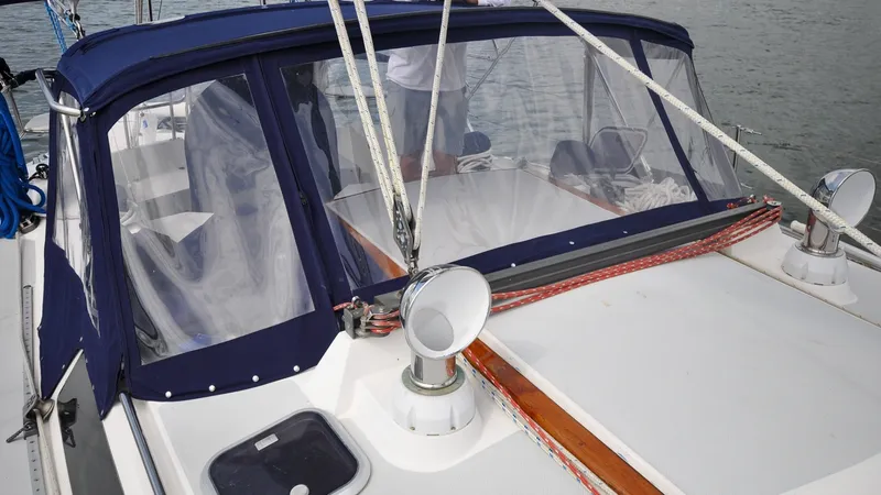 Slide: The Image of 1993 Catalina 42 | Kanga 1993 Catalina 42 sailboat cockpit with blue canopy and clear panels on a calm water setting. - 6318868