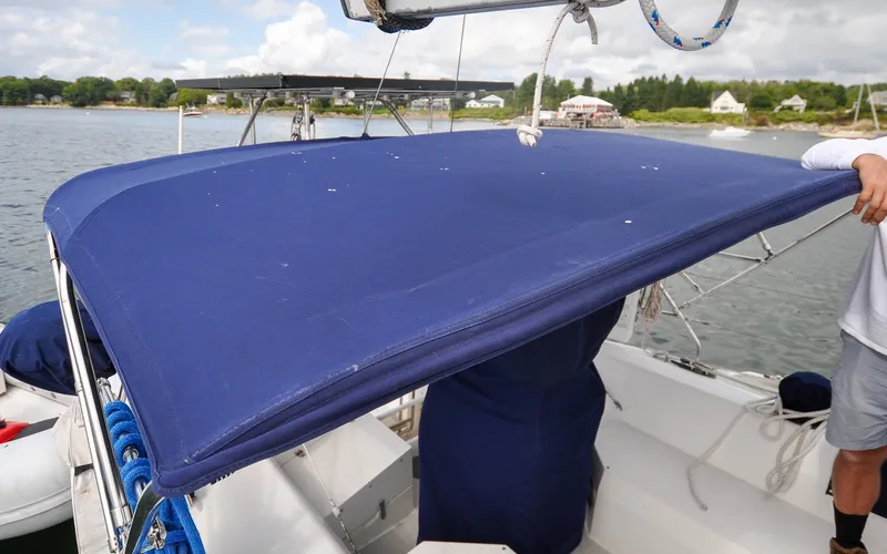 Slide: The Image of 1993 Catalina 42 | Kanga Blue bimini top on a 1993 Catalina 42 sailboat, docked near a scenic shoreline. - 6318871