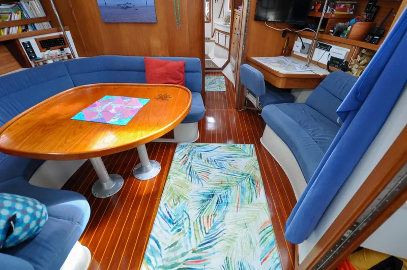 Slide: The Image of 1993 Catalina 42 | Kanga Interior of a 1993 Catalina 42 sailboat with cozy seating and wooden table. - 6318948