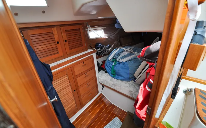 Slide: The Image of 1993 Catalina 42 | Kanga Cozy cabin interior of 1993 Catalina 42 sailboat with wooden storage and bedding. - 6318936