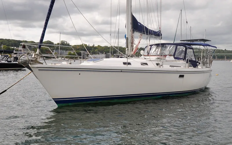 Slide: The Image of 1993 Catalina 42 | Kanga 1993 Catalina 42 sailboat anchored on calm water under cloudy skies. - 6318829