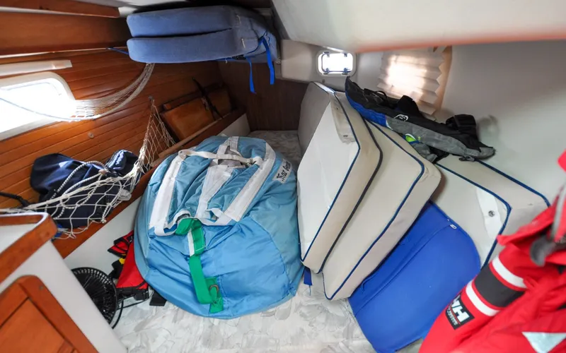 Slide: The Image of 1993 Catalina 42 | Kanga Interior cabin of a 1993 Catalina 42 sailboat with cushions and gear. - 6318942