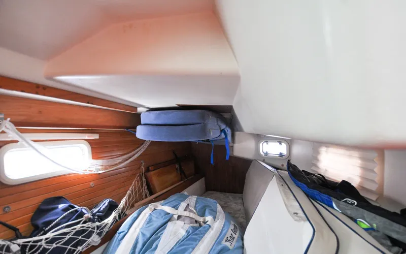 Slide: The Image of 1993 Catalina 42 | Kanga Interior cabin of a 1993 Catalina 42 sailboat with cushions and gear. - 6318939