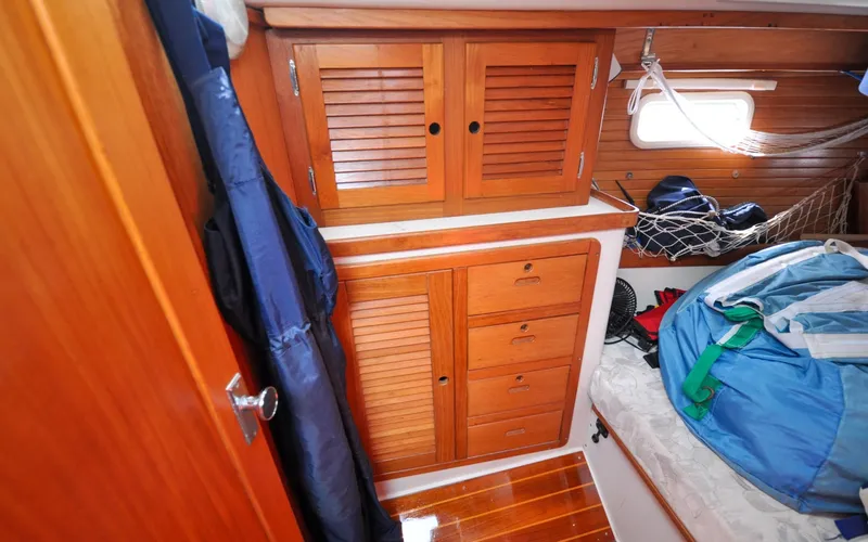 Slide: The Image of 1993 Catalina 42 | Kanga 1993 Catalina 42 sailboat interior with wooden cabinets and storage area. - 6318940