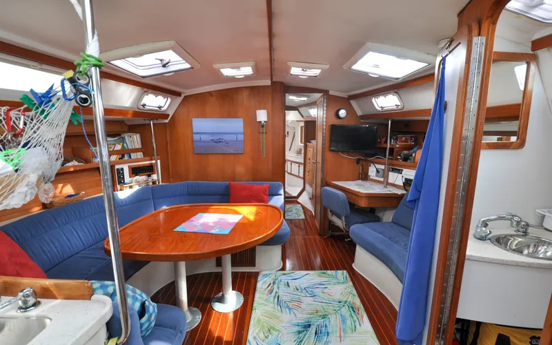 Slide: The Image of 1993 Catalina 42 | Kanga Interior of a 1993 Catalina 42 sailboat with cozy seating and wooden finishes. - 6318945