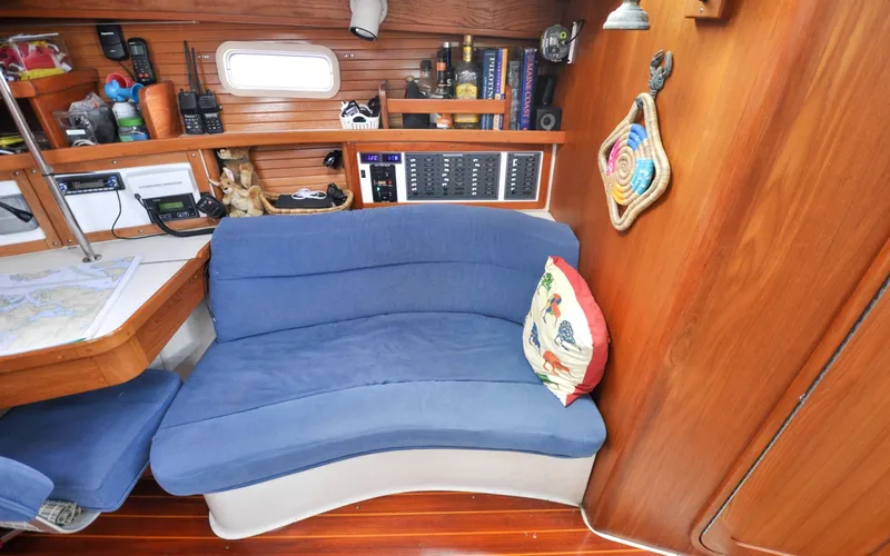 Slide: The Image of 1993 Catalina 42 | Kanga Cozy interior of 1993 Catalina 42 sailboat with blue seating and nautical decor. - 6318906
