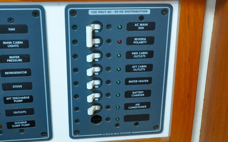 Slide: The Image of 1993 Catalina 42 | Kanga Electrical panel on a 1993 Catalina 42 sailboat, featuring circuit breakers and labels. - 6318907
