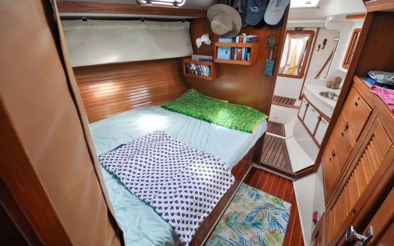 Slide: The Image of 1993 Catalina 42 | Kanga Cozy cabin interior of a 1993 Catalina 42 sailboat with bed and wooden furnishings. - 6318900