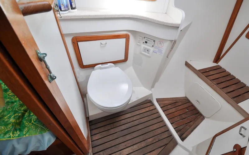 Slide: The Image of 1993 Catalina 42 | Kanga 1993 Catalina 42 yacht bathroom with wooden flooring and compact toilet. - 6318904