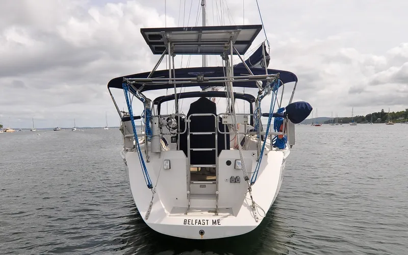 Slide: The Image of 1993 Catalina 42 | Kanga 1993 Catalina 42 sailboat docked in calm waters, rear view. - 6318841