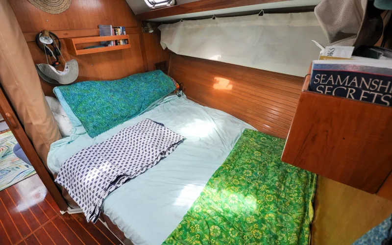 Slide: The Image of 1993 Catalina 42 | Kanga Cozy cabin interior of a 1993 Catalina 42 sailboat with colorful bedding and wooden accents. - 6318818