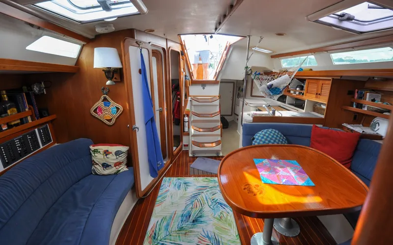 Slide: The Image of 1993 Catalina 42 | Kanga Interior of a 1993 Catalina 42 sailboat with cozy seating and wooden accents. - 6318943