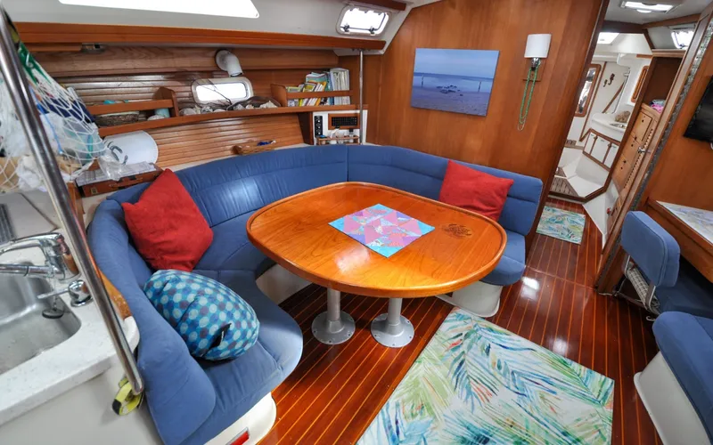 Slide: The Image of 1993 Catalina 42 | Kanga Interior of a 1993 Catalina 42 sailboat with cozy seating and wooden table. - 6318922