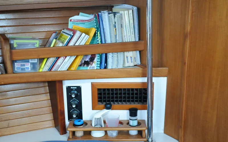 Slide: The Image of 1993 Catalina 42 | Kanga Interior of a 1993 Catalina 42 sailboat with books and navigation equipment. - 6318923