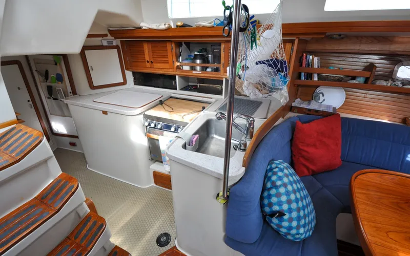 Slide: The Image of 1993 Catalina 42 | Kanga Interior of 1993 Catalina 42 sailboat with kitchen and seating area. - 6318925