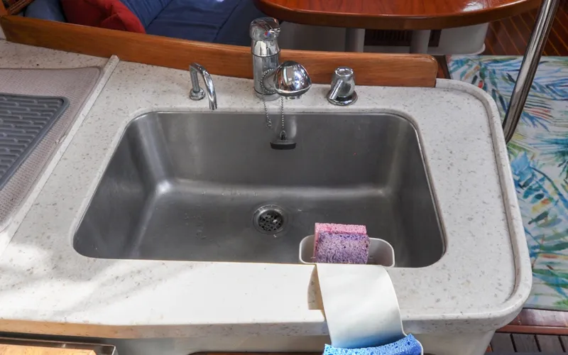 Slide: The Image of 1993 Catalina 42 | Kanga 1993 Catalina 42 yacht kitchen sink with sponges and faucet. - 6318927