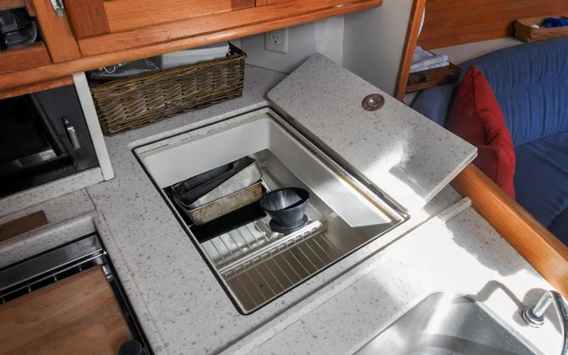 Slide: The Image of 1993 Catalina 42 | Kanga Galley kitchen in 1993 Catalina 42 sailboat with built-in storage and countertop. - 6318931