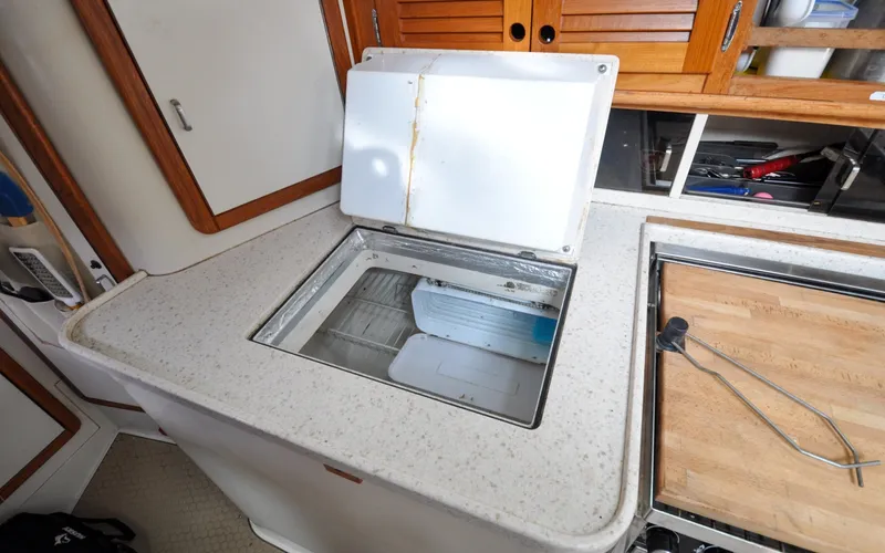 Slide: The Image of 1993 Catalina 42 | Kanga Interior of 1993 Catalina 42 yacht showing open countertop storage compartment. - 6318930