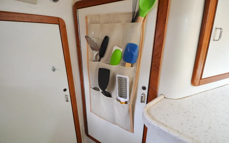 Slide: The Image of 1993 Catalina 42 | Kanga Hanging kitchen organizer with utensils in a 1993 Catalina 42 sailboat galley. - 6318933