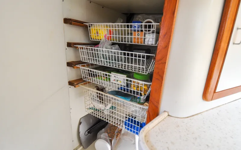 Slide: The Image of 1993 Catalina 42 | Kanga Storage shelves with wire baskets inside a 1993 Catalina 42 boat. - 6318934