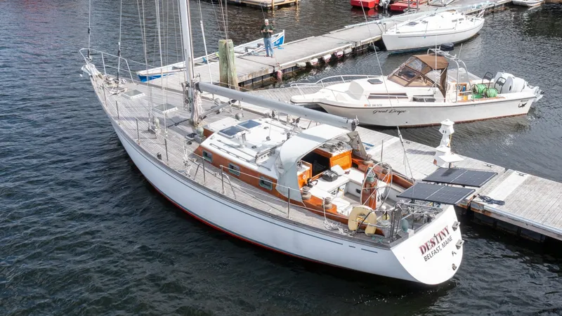 Slide: The Image of 1987 Wittholtz/Luzier 49 | Destiny Custom 1987 Wittholtz/Luzier Sloop/Cutter docked at marina, featuring solar panels and wooden deck. - 6318980