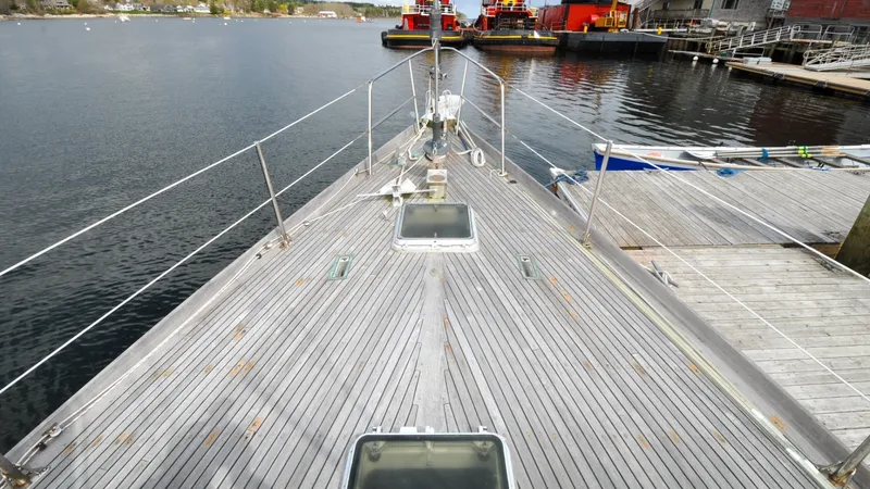 Slide: The Image of 1987 Wittholtz/Luzier 49 | Destiny 1987 Custom Wittholtz/Luzier Sloop/Cutter docked, showcasing wooden deck and marina view. - 6318982
