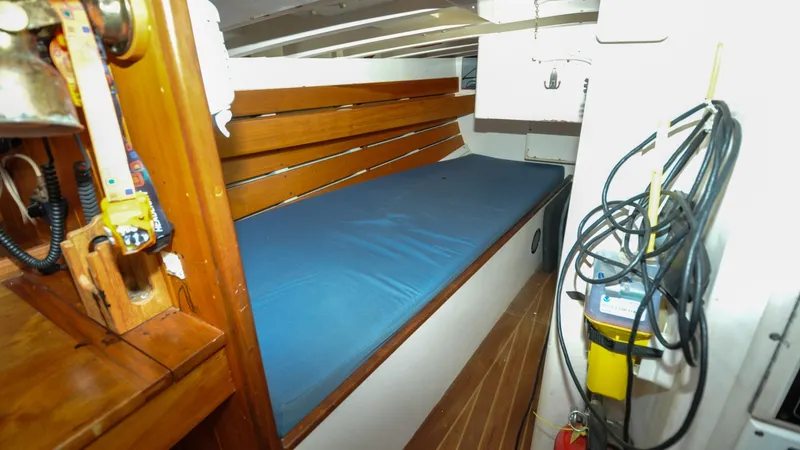 Slide: The Image of 1987 Wittholtz/Luzier 49 | Destiny Interior of 1987 Custom Wittholtz/Luzier Sloop/Cutter with wooden bench and blue cushion. - 6319008