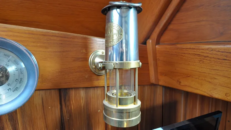 Slide: The Image of 1987 Wittholtz/Luzier 49 | Destiny Vintage brass and glass nautical lamp on 1987 Wittholtz/Luzier Sloop/Cutter wooden interior. - 6319013