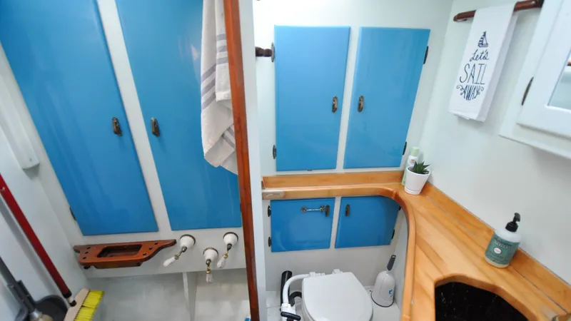 Slide: The Image of 1987 Wittholtz/Luzier 49 | Destiny Compact 1987 Custom Wittholtz/Luzier Sloop/Cutter bathroom with blue cabinets and nautical decor. - 6319017